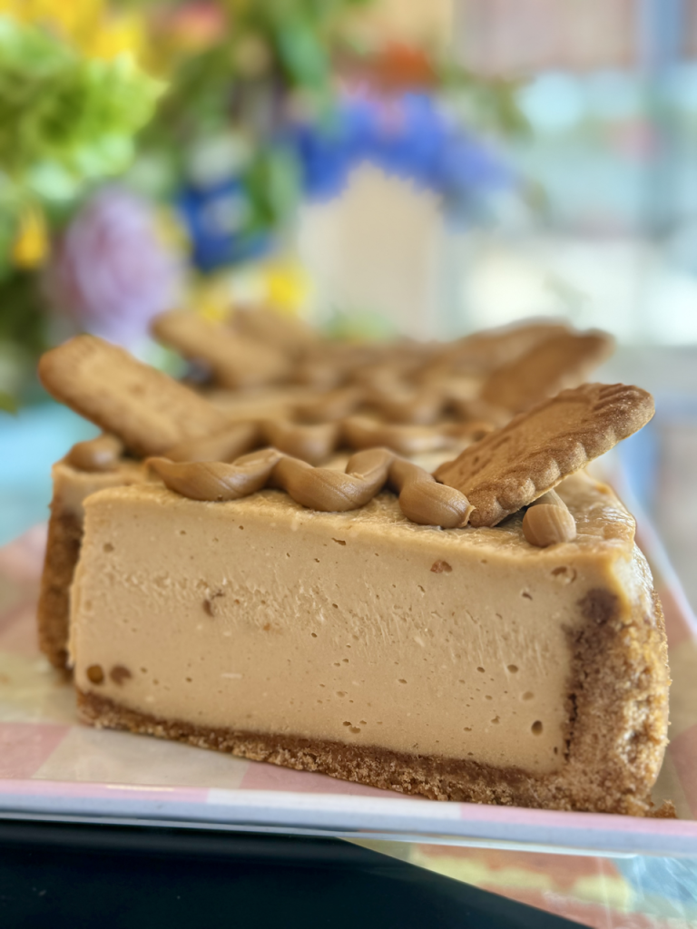 Biscoff cheesecake slices with cookies on top on a display